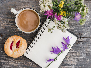 Cup of hot, aromatic coffee and a beautiful flowers. Close-up, view from above, indoors