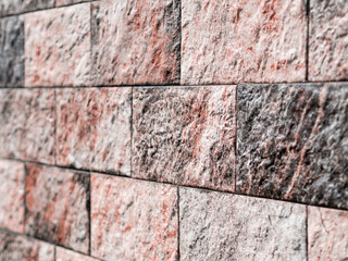 Texture of artificial stone. Stone fence. Wall in the park.