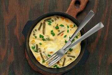 Healthy breakfast - frittata with vegetables and coffee with cookies on the table. Top view