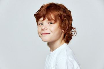 Cheerful redhead boy smile white t-shirt cropped view studio 