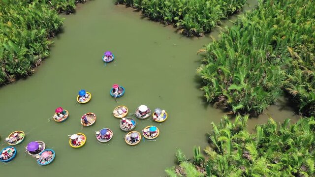 Traditional Basket Boats in Coconut Village Hoi An Vietnam. Birdseye Aerial View of Tourists on Tour in Authentic Fishing Vessel. Drone Shot