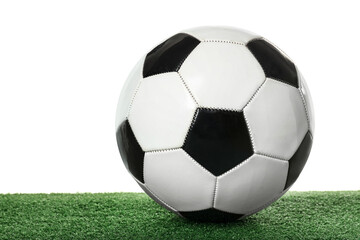Soccer ball on green field against white background