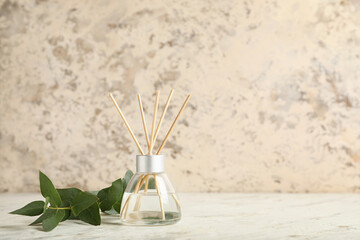 Reed diffuser and eucalyptus on table