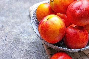 Plate with sweet ripe nectarines on table