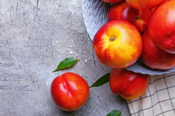 Plate with sweet ripe nectarines on table