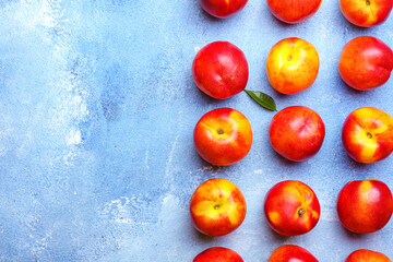Sweet ripe nectarines on color background