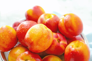 Fototapeta na wymiar Sweet ripe nectarines in colander on table, closeup