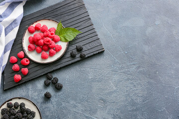 Tasty fresh berries on dark background