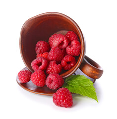 Jug with ripe raspberries on white background