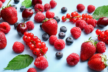 Fototapeta na wymiar Tasty fresh berries on color background