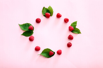 Frame made of ripe raspberries on color background