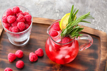 Jug of cold raspberry tea on table
