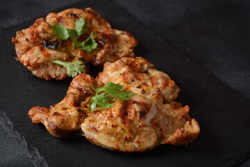 Grilled chicken steaks with tomatoes, herbs, olive oil, pepper,sliced cucumber and herbs.