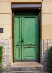 Antique wooden door with decorative elements. Vertical orientation, selective focus, front view. Horizontal orientation, selective focus