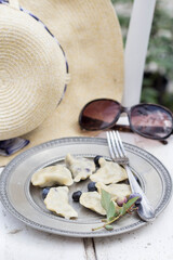 tasty, homemade dumplings with blueberries on the white wooden table