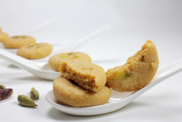 Milk peda is a traditional Indian sweet made from milk or khoya and garnished with pistachio to celebrate festivals like Diwali.