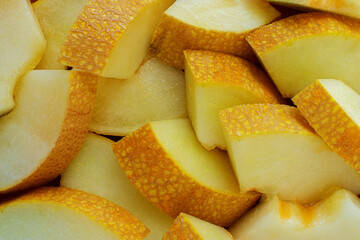 Honeydew melon slices, full frame food background, top view.