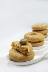 Milk peda is a traditional Indian sweet made from milk or khoya and garnished with pistachio to celebrate festivals like Diwali.
