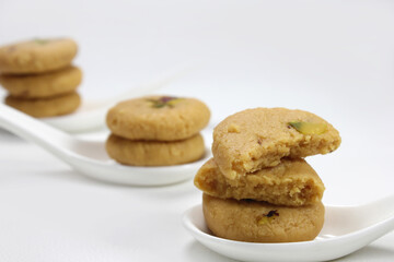 Milk peda is a traditional Indian sweet made from milk or khoya and garnished with pistachio to celebrate festivals like Diwali.