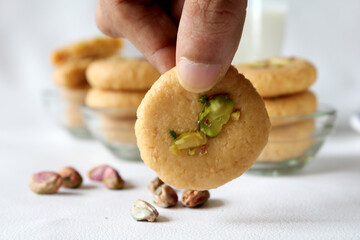 Milk peda is a traditional Indian sweet made from milk or khoya and garnished with pistachio to celebrate festivals like Diwali.
