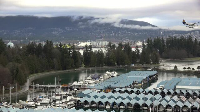 View of Royal Vancouver Yacht Club seen from Westin Bayshore Hotel, seaplane flying through frame, Stanley Park, static