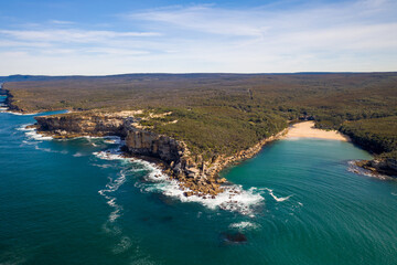 Fototapeta na wymiar Aerial view of rugged coastline on a sunny bright day