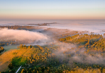 Fototapeta na wymiar Morning fog over fields, hills and forest