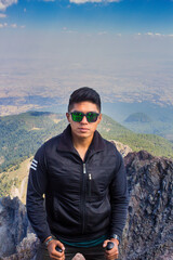 Naklejka premium mid adult mountaineer smiling from the Malinche mountains, portrait.Copy space