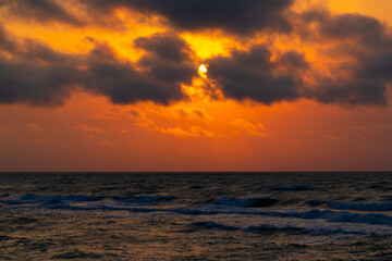 Obraz na płótnie Canvas Sun in the clouds over the sea
