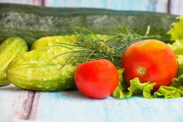 Fresh vegetables on a table, tomatoes cucumber salad dill