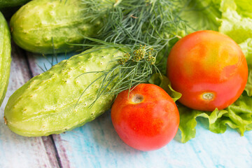 Fresh vegetables on a table, tomatoes cucumber salad dill