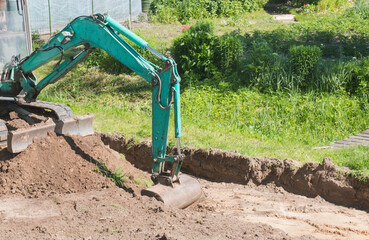Excavator bucket digs sand