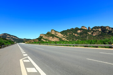 Empty highway, blue sky and white clouds landscape