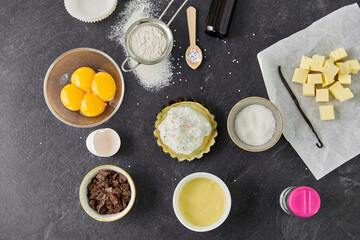 food, culinary and recipe concept - baking dish with dough and cooking ingredients on table