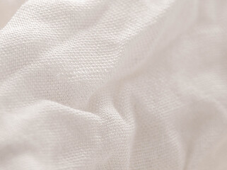 Texture of white fabric shows a soft, comfortable feel. Abstract background.