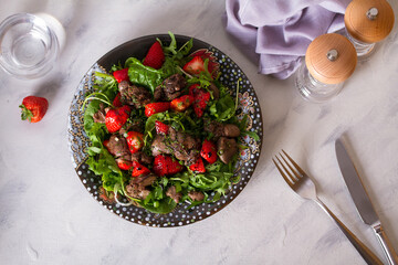 Chicken liver salad with strawberries and arugula. Liver and berries salad. overhead horizontal photo