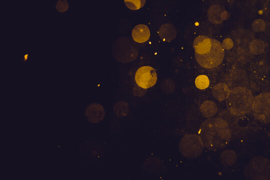 Dark Abstract Gold bokeh sparkle on black © pandaclub23