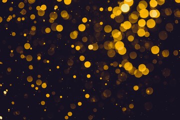 Fototapeta na wymiar Abstract gold defocused bokeh of lights in dark