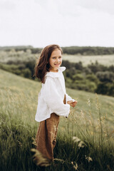 little girl in a field of flowers at sunset