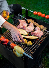 Cooking corn, meat and vegetables on the grill. Outdoor barbecue