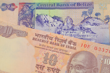 A macro image of a orange ten rupee bill from India paired up with a colorful two dollar bill from Belize.  Shot close up in macro.