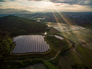 メガソーラー（太陽光発電パネル）に朝日の射す美しい風景を空撮した