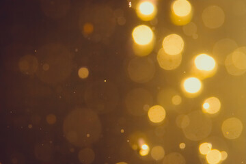 Dark Abstract Gold bokeh sparkle on black background