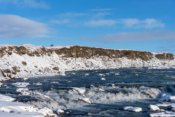 Picturesque winter landscape view of Urridafoss waterfall in Iceland.