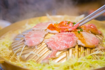Grill food in a brass pan