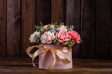Bouquet of beautiful bright rose flowers in a gift cylindrical cardboard box