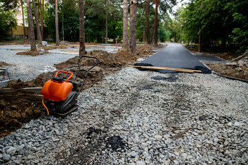 Laying asphalt on a pedestrian path in a city park, landscaping