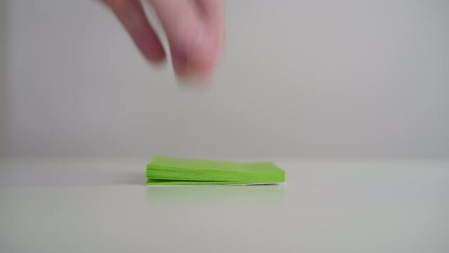 Post note being peeled in an office space