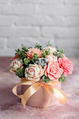 Bouquet of beautiful bright rose flowers in a gift cylindrical cardboard box