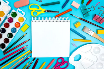 Kids art tools. Sketchbook notepad open blank page mockup top view. Empty white sheet copy space. DIY craft equipment. Drawing and painting supplies for children. Back to art school concept flatly.